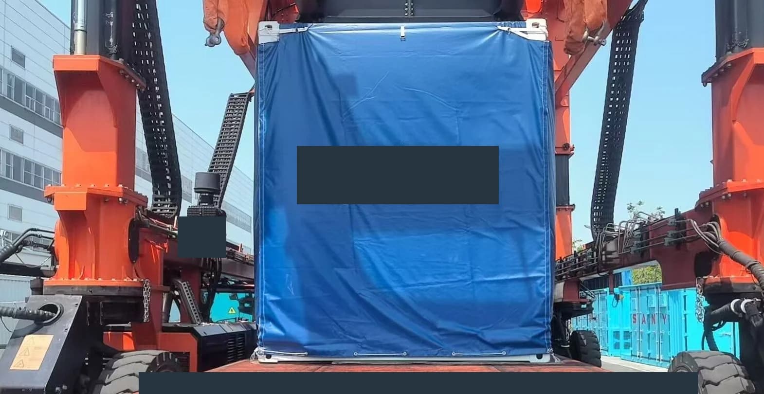 Shipment photograph: covered unit, handling equipment and trailer at the loading stage.