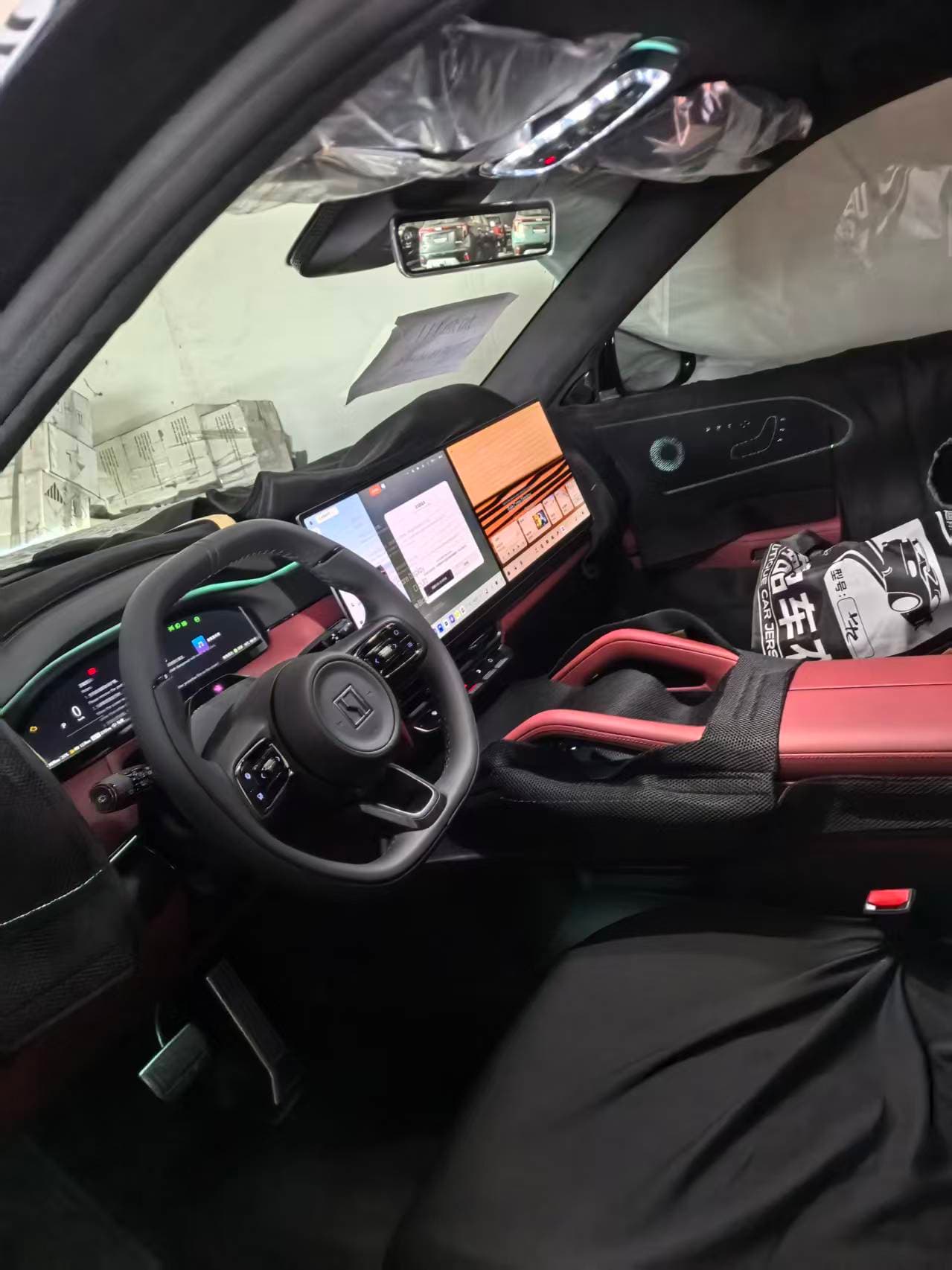 ZEEKR 8X exhibition vehicle interior with steering wheel, dashboard screens and red-and-black cabin