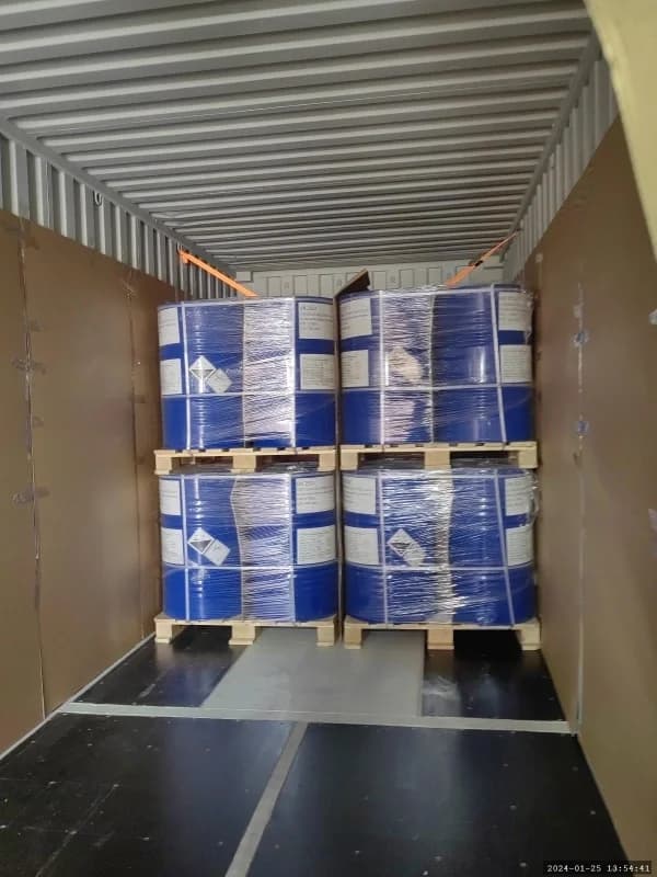 Historical work photograph: drummed cargo being loaded in tiers.