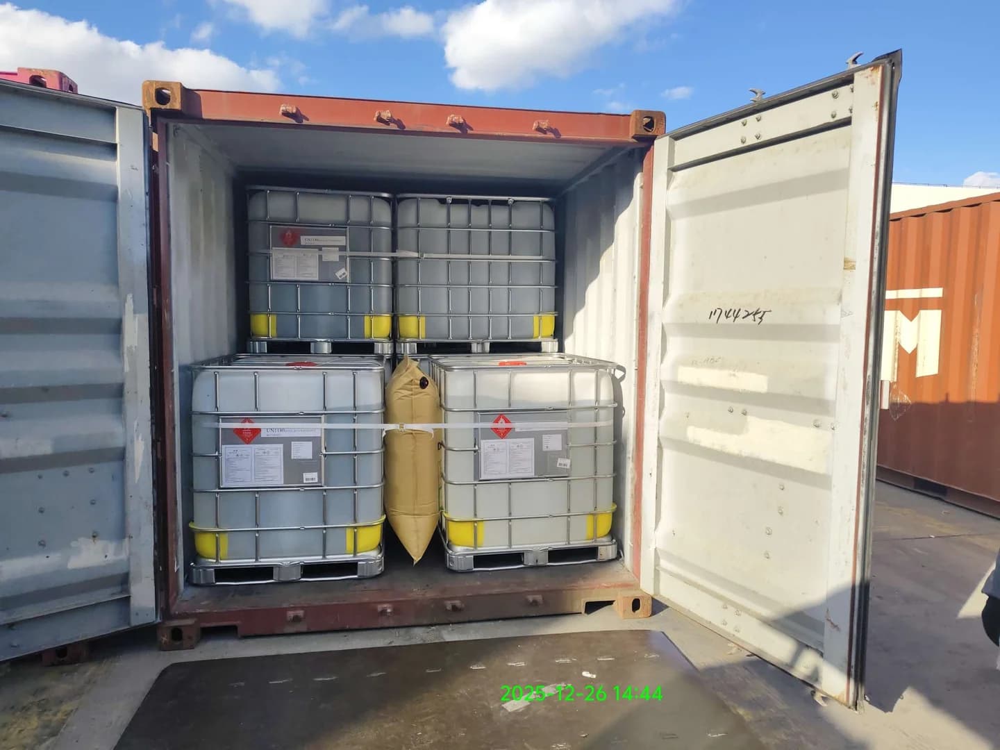 Historical work photograph: dunnage airbag and restraint in an 18-IBC load.