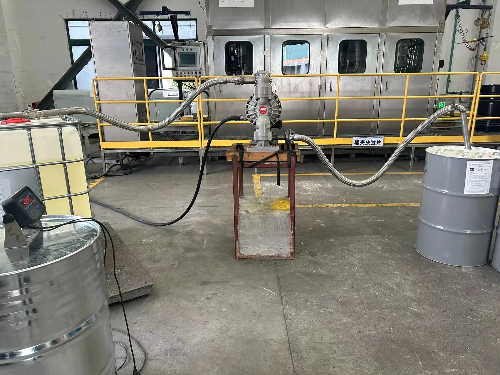 On-site photograph: transfer pump, hoses and containers.