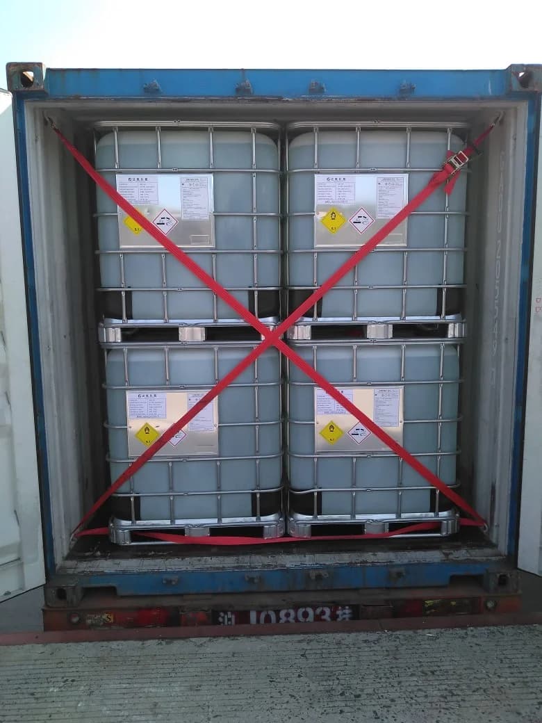 Shipment photograph: the door-end view after loading and lashing 20 IBCs.