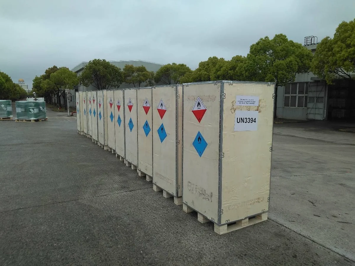 Shipment photograph: crated cargo with UN3394 markings and hazard labels.